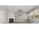 Spacious living room with a cozy fireplace, ceiling fan, and abundant natural light at 206 Woodbrook Way, Moncks Corner, SC 29461