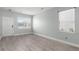 Bright living room with new flooring, a freshly painted white door, and many windows at 206 Woodbrook Way, Moncks Corner, SC 29461