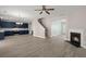 Open-concept living space features modern fireplace, staircase, and stylish kitchen with stainless steel appliances at 206 Woodbrook Way, Moncks Corner, SC 29461
