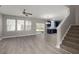 Open living space featuring sleek flooring, natural light, and a glimpse of the modern kitchen at 206 Woodbrook Way, Moncks Corner, SC 29461