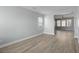 Open living area with modern flooring, natural light, and views into the kitchen and hallway at 206 Woodbrook Way, Moncks Corner, SC 29461