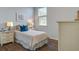 The bedroom showcases a single bed, sleek wood floors, ample lighting, and a stylish, modern nightstand at 2279 Macallan Blvd, Ravenel, SC 29470