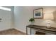 Entryway featuring a white door, a decorative lamp and potted plant, and artwork displayed on the wall at 2279 Macallan Blvd, Ravenel, SC 29470