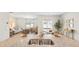 Spacious kitchen with granite countertop island, stainless steel sink, and open view of the living and dining areas at 2279 Macallan Blvd, Ravenel, SC 29470