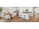 Bright kitchen with white cabinets, granite countertops, island with seating, and view of the dining area at 2279 Macallan Blvd, Ravenel, SC 29470