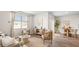 Inviting living room with neutral decor, large windows, and seamless flow to the adjacent dining area at 2279 Macallan Blvd, Ravenel, SC 29470