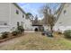 Backyard featuring an outdoor kitchen, stone patio, firepit with chairs, and privacy fence at 2369 Chadbury Ln, Mount Pleasant, SC 29466