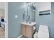 Cozy powder room with a vanity cabinet, wall mirror with vanity light, and adjacent toilet at 2369 Chadbury Ln, Mount Pleasant, SC 29466