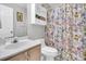 Functional bathroom with a floral shower curtain, a single vanity and a toilet under the cabinet at 2369 Chadbury Ln, Mount Pleasant, SC 29466