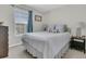 Cozy bedroom with a window, soft carpet, calming colors, and a comfortable bed topped with decorative pillows at 2369 Chadbury Ln, Mount Pleasant, SC 29466