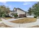 Beautiful home with a covered front porch, black shutters, and landscaped front yard with a paved driveway at 2369 Chadbury Ln, Mount Pleasant, SC 29466