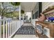 Relaxing covered front porch with a stylish rug, a hanging plant, and a comfortable porch swing at 2369 Chadbury Ln, Mount Pleasant, SC 29466