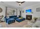 Comfortable living room featuring a blue sectional, fireplace, and ceiling fan at 2369 Chadbury Ln, Mount Pleasant, SC 29466