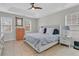 Spacious main bedroom with a tray ceiling, ceiling fan, carpet, and a comfortable bed with a floral pattern at 2369 Chadbury Ln, Mount Pleasant, SC 29466