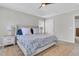 Spacious main bedroom with a tray ceiling, ceiling fan, carpet, and a comfortable bed with a floral pattern at 2369 Chadbury Ln, Mount Pleasant, SC 29466