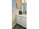 Bathroom vanity with white cabinets, marble countertop, framed art, and modern fixtures at 263 Stefan Dr, Charleston, SC 29412