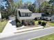 Inviting two-story home with a red door, complemented by lush landscaping and a detached garage at 263 Stefan Dr, Charleston, SC 29412
