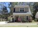 Close up of a charming two-story home with a red door and landscaped front yard at 263 Stefan Dr, Charleston, SC 29412