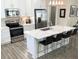 Bright kitchen showcasing stainless steel appliances, marble countertops, and a large island with barstool seating at 263 Stefan Dr, Charleston, SC 29412