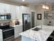 Modern kitchen boasts stainless steel appliances, marble countertops, and a stylish island at 263 Stefan Dr, Charleston, SC 29412