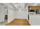 Open dining area with hardwood floors, modern light fixture, and adjacent kitchen area at 268 Alexandra Dr # 9, Mount Pleasant, SC 29464
