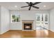 Cozy living room features a fireplace, hardwood floors, and natural light from large windows at 268 Alexandra Dr # 9, Mount Pleasant, SC 29464