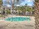 Community pool surrounded by palm trees, lounge seating, and well-maintained landscaping for a peaceful and luxurious experience at 268 Alexandra Dr # 9, Mount Pleasant, SC 29464
