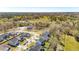 Aerial view of a suburban neighborhood nestled amongst lush green trees, showcasing ponds and winding streets at 2916 Cavalcade Cir, Johns Island, SC 29455