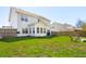 Large, grassy backyard with an outdoor seating area and a patio with a barbecue, ideal for relaxation at 2916 Cavalcade Cir, Johns Island, SC 29455