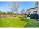 Spacious backyard with a well-maintained lawn, wooden fence, patio and mature shade trees at 2916 Cavalcade Cir, Johns Island, SC 29455