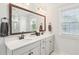 Bathroom with double sink vanity with a large mirror and bronze fixtures at 2916 Cavalcade Cir, Johns Island, SC 29455