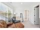 Bright bedroom featuring large window with blinds, comfortable seating area, and neutral decor at 2916 Cavalcade Cir, Johns Island, SC 29455