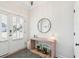 Bright entryway with a stylish console table, a round mirror, and ample natural light streaming in through the front door at 2916 Cavalcade Cir, Johns Island, SC 29455