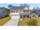 Inviting two-story home featuring a stone-accented garage, a covered front porch, and a lush front yard at 2916 Cavalcade Cir, Johns Island, SC 29455