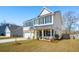 Charming two-story home with a stone-accented facade, a covered porch, and a manicured front lawn at 2916 Cavalcade Cir, Johns Island, SC 29455
