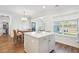 Well-lit kitchen featuring an island with seating, a dining table, and seamless connectivity to the rest of the home at 2916 Cavalcade Cir, Johns Island, SC 29455