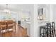 Open-concept kitchen with white cabinets, a breakfast bar, and modern appliances, seamlessly connected to the dining area at 2916 Cavalcade Cir, Johns Island, SC 29455