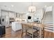 Bright kitchen with white cabinets and wood flooring leading to stairs at 2916 Cavalcade Cir, Johns Island, SC 29455