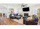 Spacious living room with a cozy fireplace, a ceiling fan, and comfortable leather seating, ideal for relaxation and entertainment at 2916 Cavalcade Cir, Johns Island, SC 29455