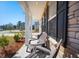 Inviting front porch featuring comfortable Adirondack chairs, perfect for enjoying the outdoors, with stone accents at 2916 Cavalcade Cir, Johns Island, SC 29455