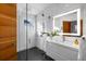 Modern bathroom featuring a glass enclosed shower, sleek white vanity, and elegant marble walls for a spa-like experience at 301 Broad St # 1, Charleston, SC 29401