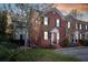 Charming brick home showcasing curb appeal with mature trees, manicured lawn, and inviting front porch at 301 Broad St # 1, Charleston, SC 29401