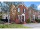 Charming brick home with manicured lawn, lush trees, and front entrance exuding curb appeal and timeless elegance at 301 Broad St # 1, Charleston, SC 29401