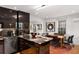 Modern kitchen boasts sleek black cabinetry, marble countertops, stainless steel appliances, and an adjacent dining area at 301 Broad St # 1, Charleston, SC 29401