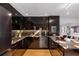 Bright kitchen featuring black cabinets, marble countertops, stainless steel appliances and hardwood flooring at 301 Broad St # 1, Charleston, SC 29401