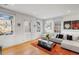 Bright living room features hardwood floors, contemporary furnishings, and natural light from large windows at 301 Broad St # 1, Charleston, SC 29401