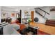 Open-concept living area with hardwood floors, designer furnishings, and seamless flow into the dining space at 301 Broad St # 1, Charleston, SC 29401