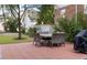 Outdoor patio features brick pavers, an outdoor dining set, and lush landscaping, perfect for entertaining guests at 301 Broad St # 1, Charleston, SC 29401