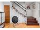 Modern staircase with glass railing and wood treads, complemented by hardwood flooring and a unique speaker at 301 Broad St # 1, Charleston, SC 29401