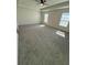 Spacious bedroom features neutral walls, plush gray carpeting, two bright windows, and a ceiling fan at 3059 Adventure Way, Ladson, SC 29456